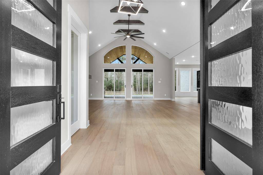 A grand entryway with high ceilings, elegant lighting, and a welcoming foyer leading into the main living areas.