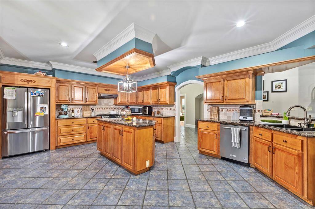 This spacious kitchen is truly a chef's dream! The beautifully maintained granite countertops provide more than enough space for prepping and cooking.