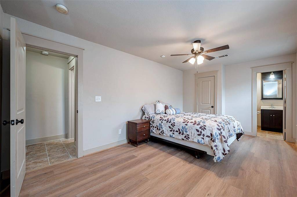 Here you can see where the hall bath is, one of the closets, and a quick peek of the en suite primary bath to the right.