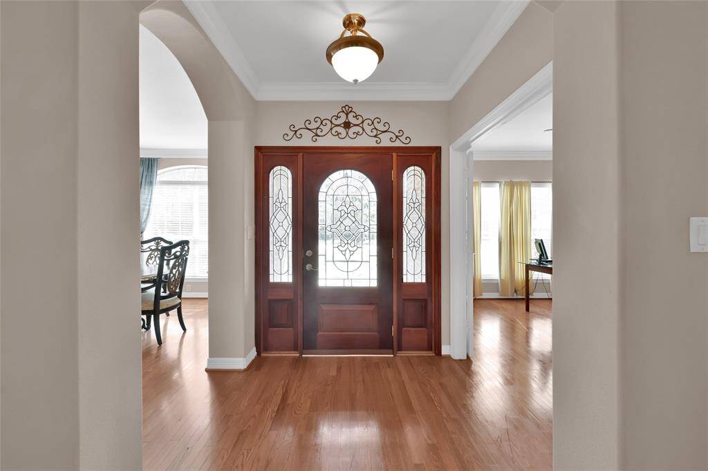 Greet guests to your home through a three-piece Mahogany wood door with leaded glass inserts. Beautiful hard woods add to a beautiful foyer.