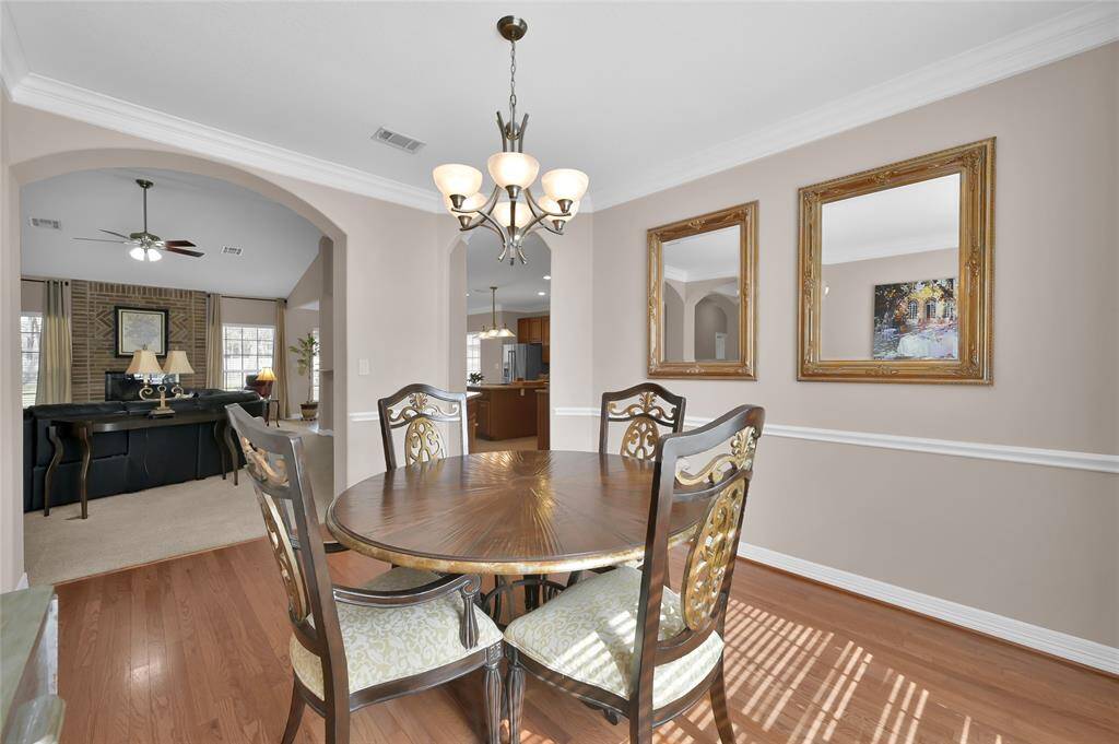 Entertain family and friends in the dining area featuring a stylish chandelier and large window providing abundant natural light that fills not just the dining room, but into the living room as well.