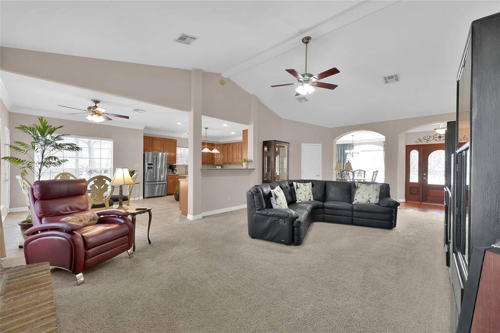 The living room seemlessly flows into the kitchen. A breakfast bar separates the two rooms and provides space for seating as well.