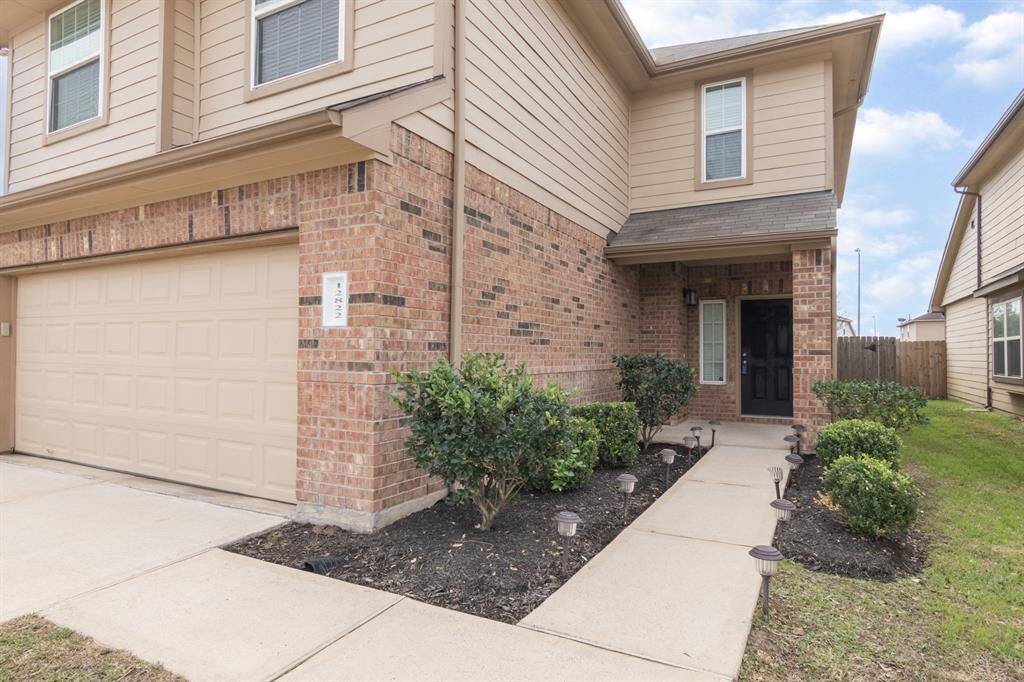 This is a modern two-story home with a brick and siding exterior.