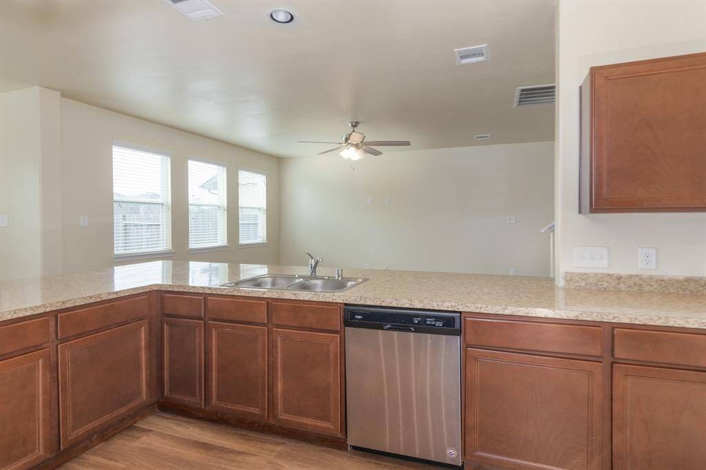It features a large window area for natural light and a ceiling fan in the adjacent living space.