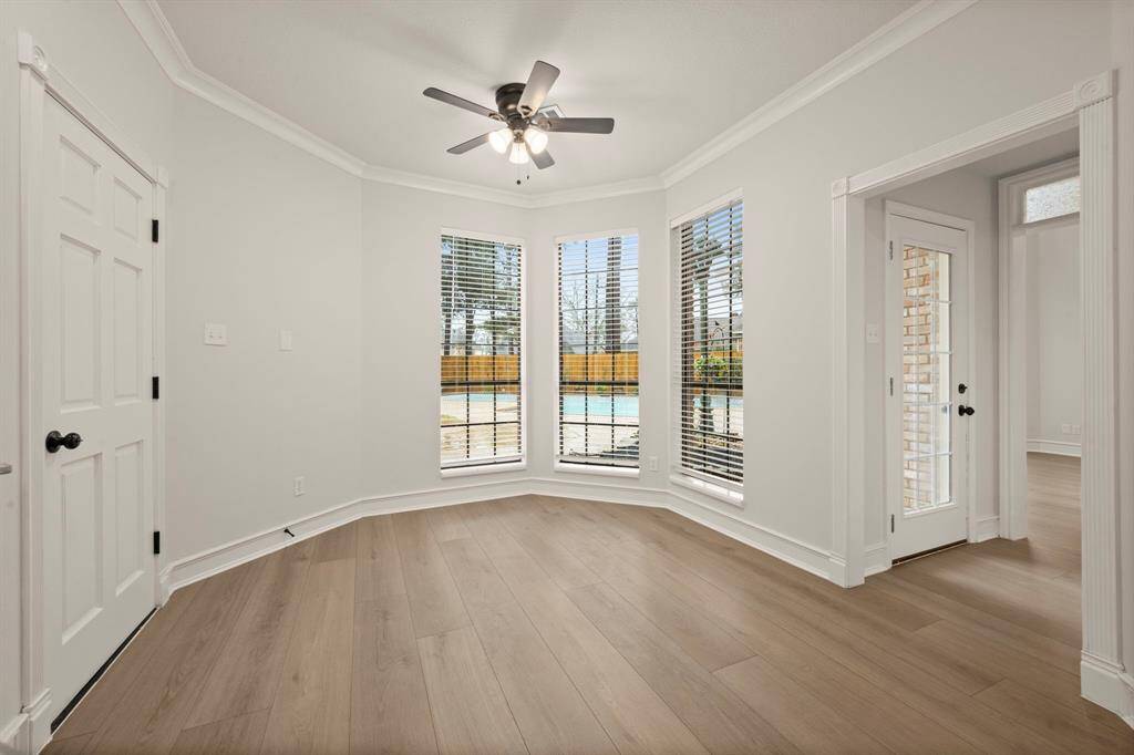 Bathed in natural light, the breakfast room is the perfect spot to start your day with a cup of coffee. Large windows offer a serene view of the backyard, bringing the beauty of the outdoors inside.