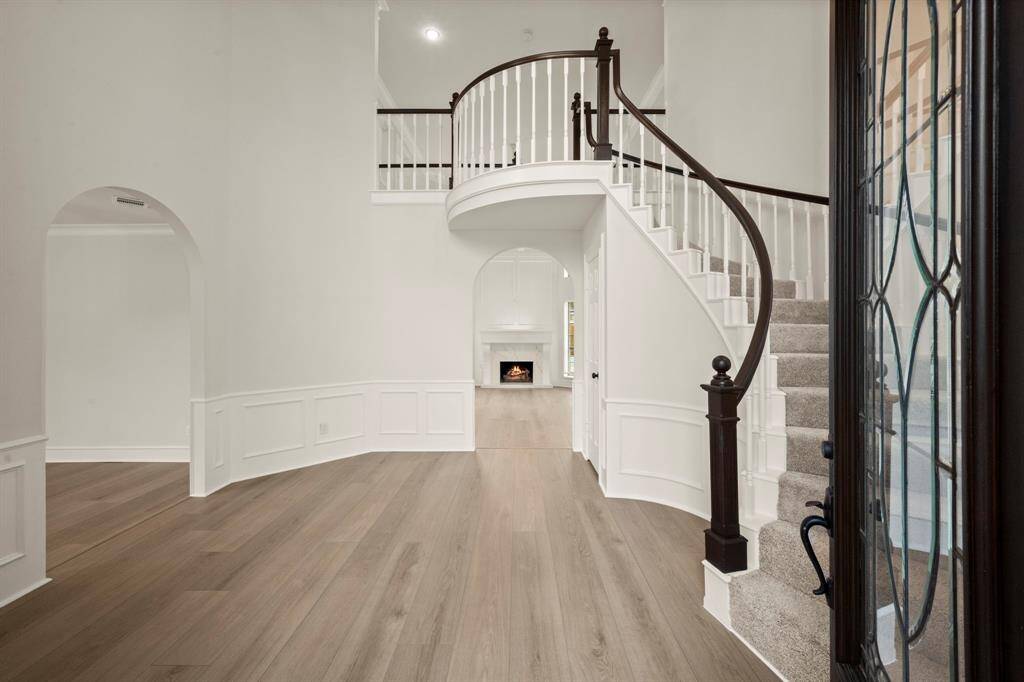 From the moment you step inside, you’ll be captivated by the grand curved staircase, exquisite crown molding, and soaring 18ft ceilings.