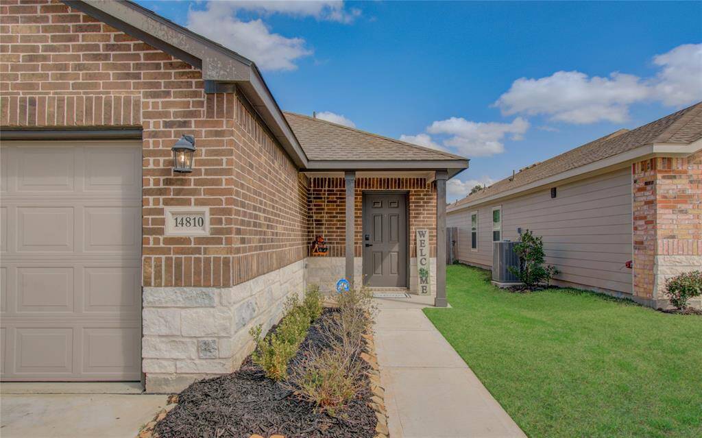 Charming brick home featuring a welcoming front porch and neatly landscaped yard. The entrance is framed by a well-maintained walkway, adding to its curb appeal.