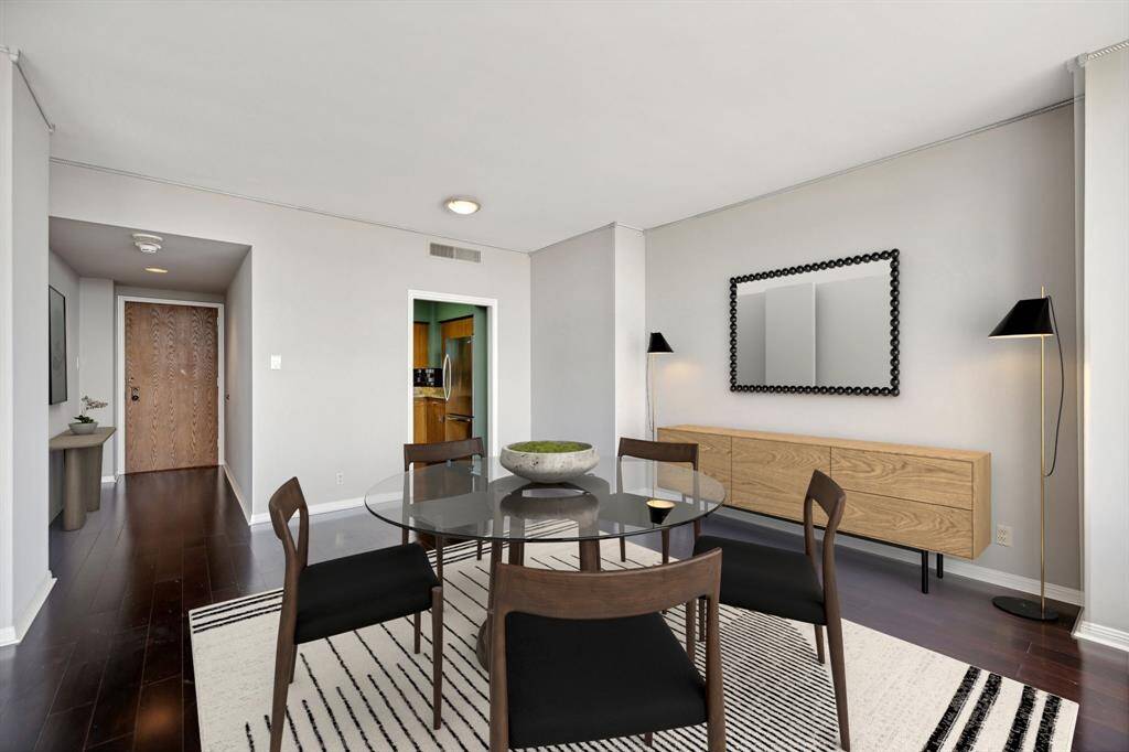 Dining area shown open to the entry and kitchen. Image shown virtually staged.