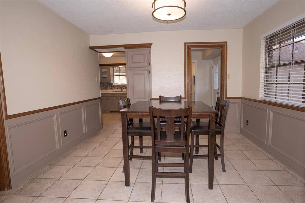 Additional view of the breakfast room, showing a glimpse of the kitchen at the background.