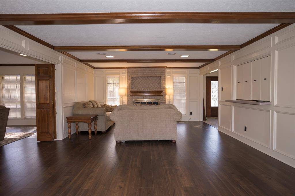 Another view of the spacious living room, offering even more room to relax and entertain.