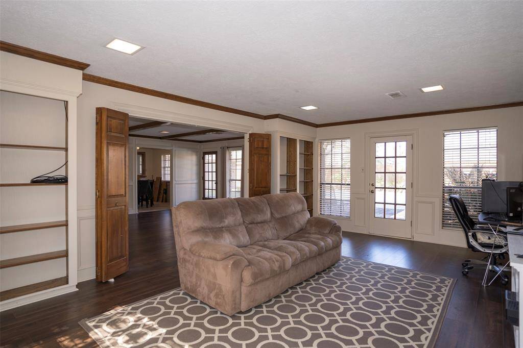 The room features large glass windows, filling the space with natural light and creating a bright, airy atmosphere.