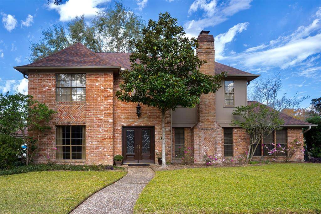 This home features a stunning brick and wood exterior.