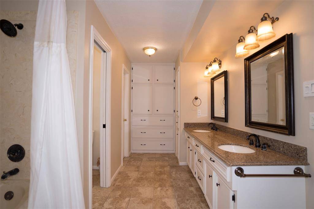 The main bathroom features a tub and shower combo, double sinks, and a spacious walk-in closet for added convenience.