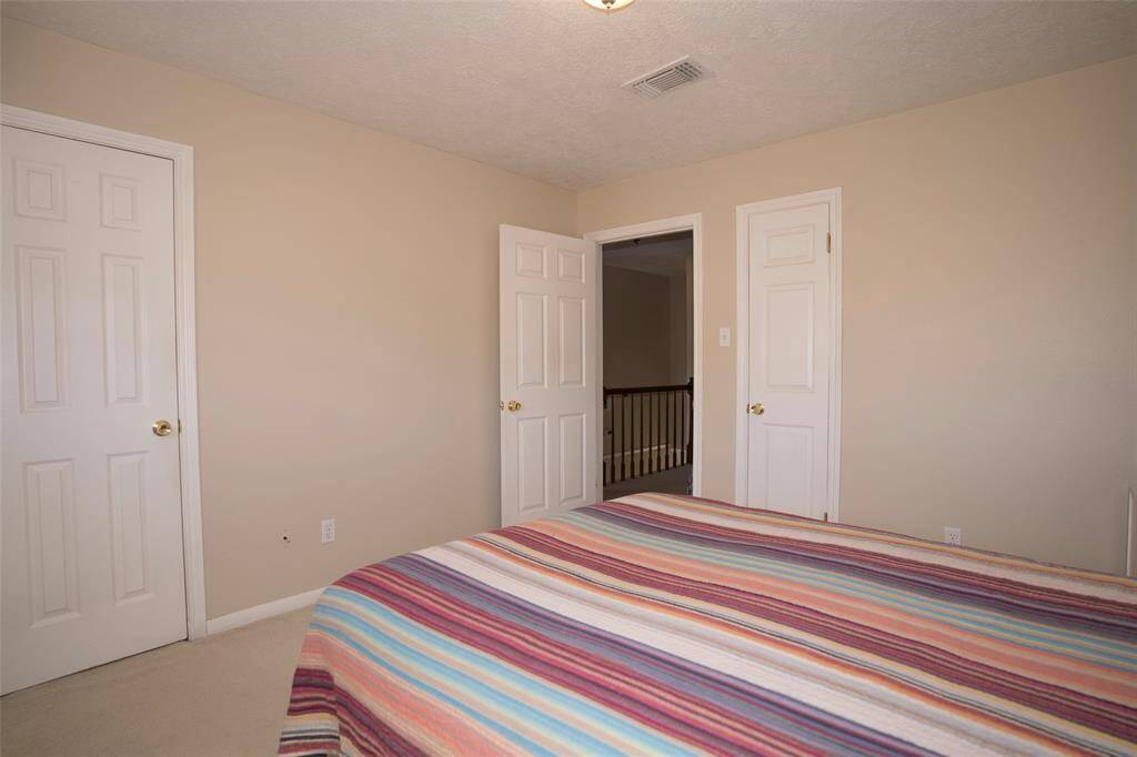Another view of the third bedroom, showcasing its cozy layout and potential for personalization.