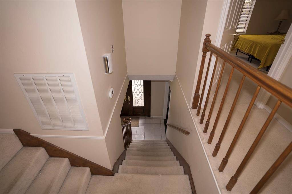 The staircase leading down to the first floor, offering a smooth transition between levels.