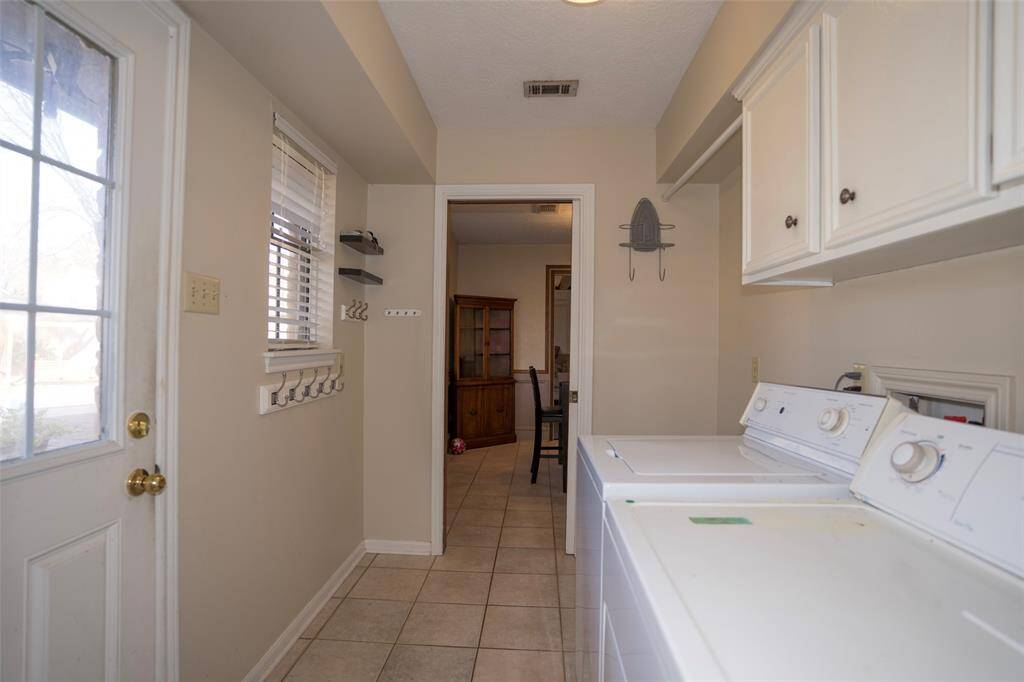 The laundry room is conveniently located for easy access and efficiency.