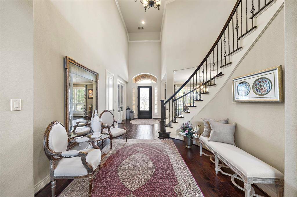 Spacious grand entrance features a private office with glass inlay doors.