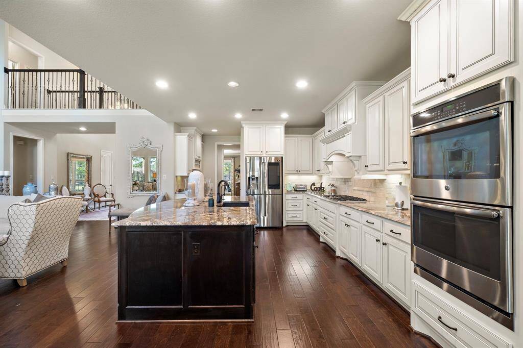 The kitchen boasts an extra large island, double ovens and abundant cabinets and counter space!