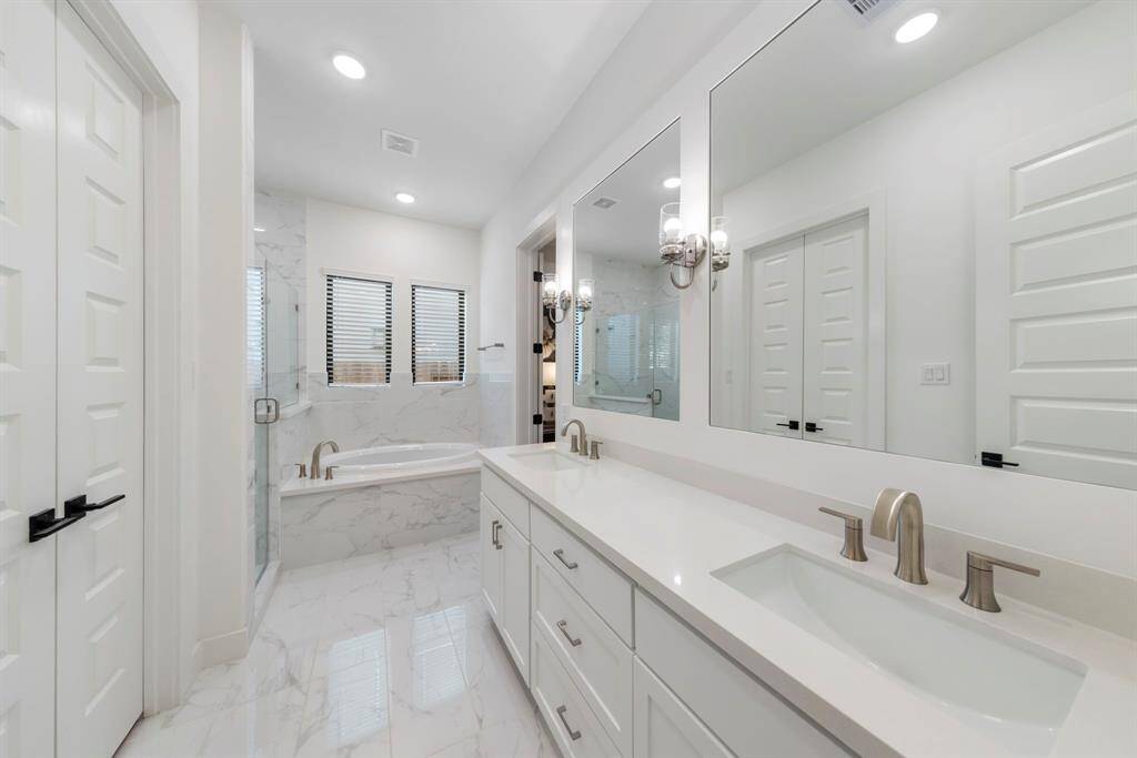 Through the double doors, you'll find the expansive walk-in closet featuring custom built-ins for ample storage and organization.