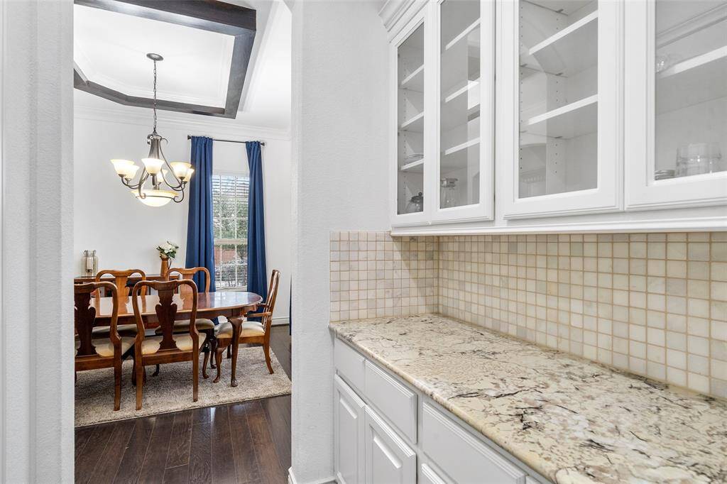 The exquisite Butler's Pantry spans between the kitchen and large dining room.  Note all the glass cabinets and storage. The large walk in pantry is just opposite of the Butler's Pantry.