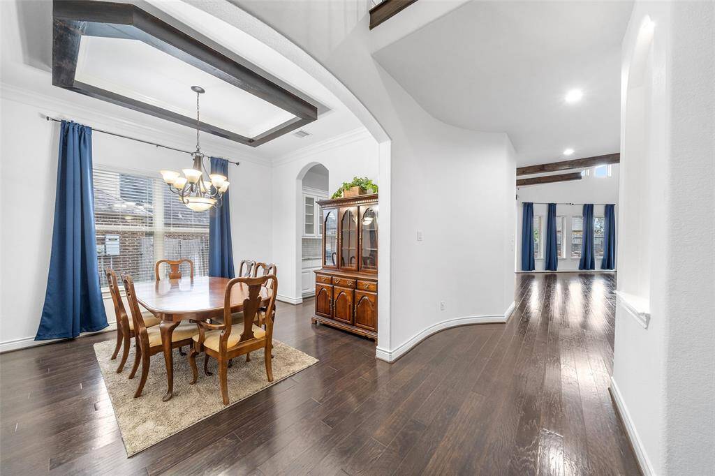 The large light and bright dining area with large windows provide natural light creating a seamless flow ideal for entertaining. The rich wood flooring spans from the front door all the way throughout the living areas.