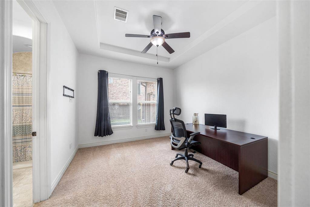 This downstairs bedroom with an ensuite bathroom is being used currently for an additional office area.