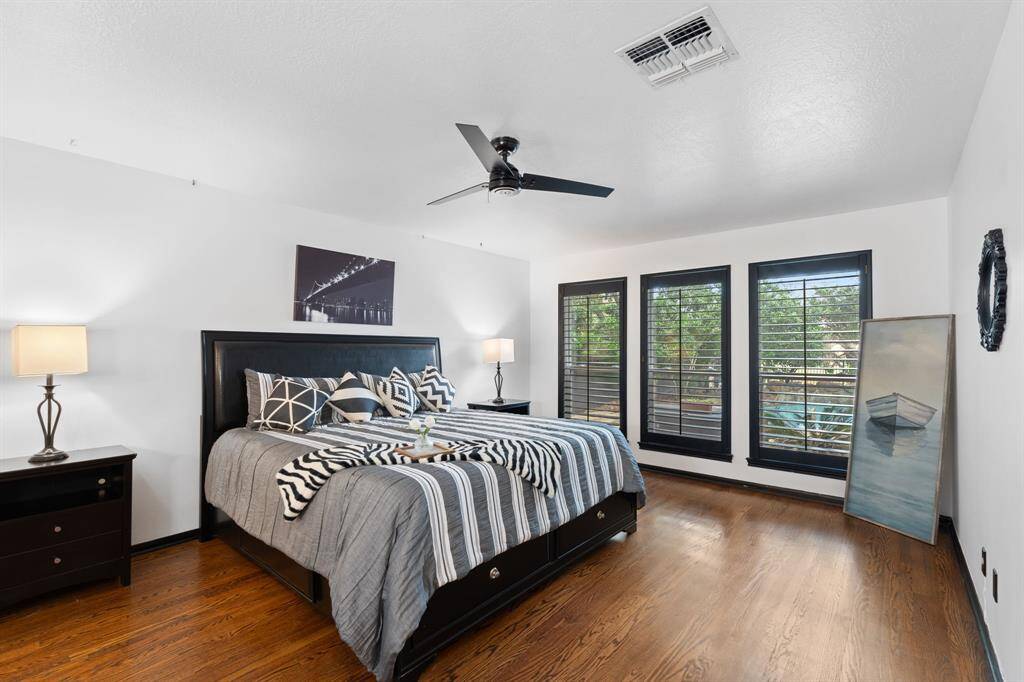 The owner's suite features hardwood flooring, plantation shutters and ample space.