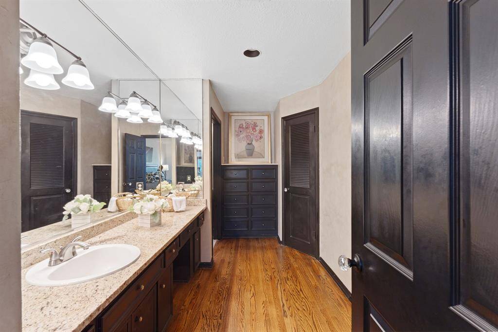 Gorgeous spa-like bathroom with double vanities, new lights, built-in linen cabinets and walk-through master closet.