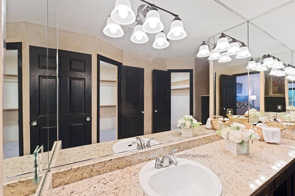 This close-up highlights the new lighting and primary closet with 2 doors to walk-through from either side.