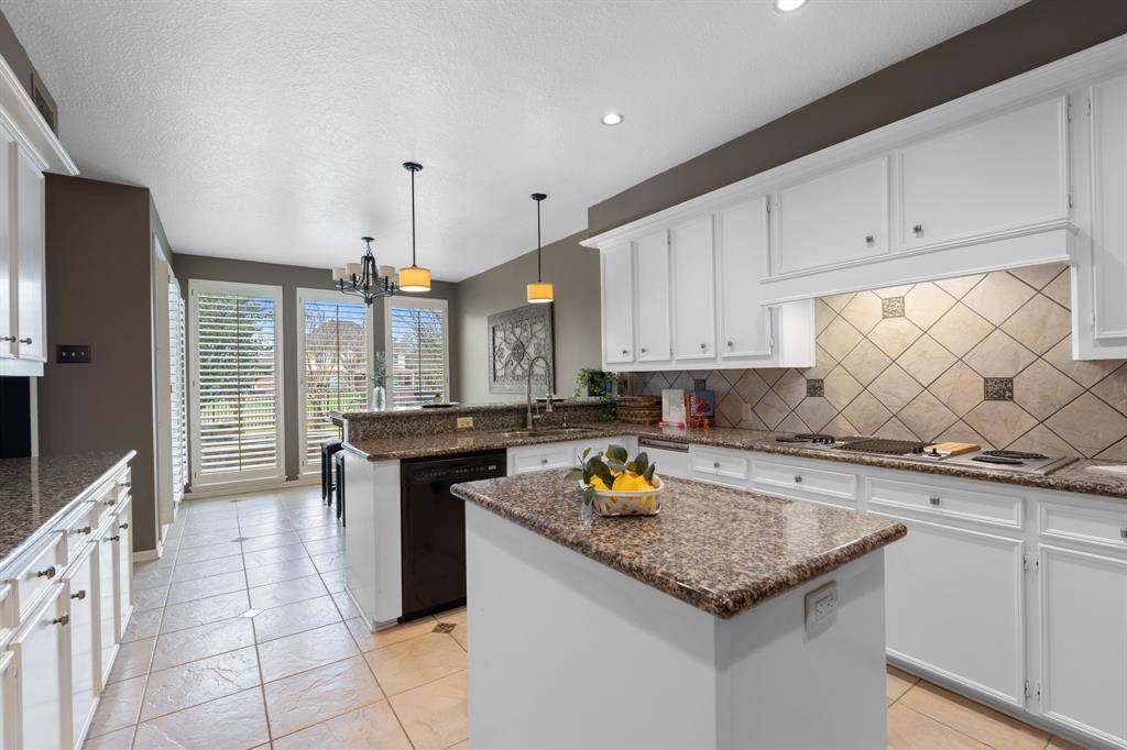 What a beautiful island kitchen with undermount lighting, granite countertops and ample storage.