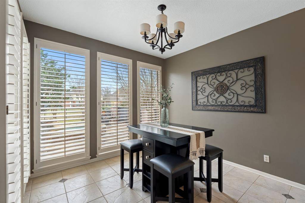 The breakfast area overlooks the backyard and features custom shutters.