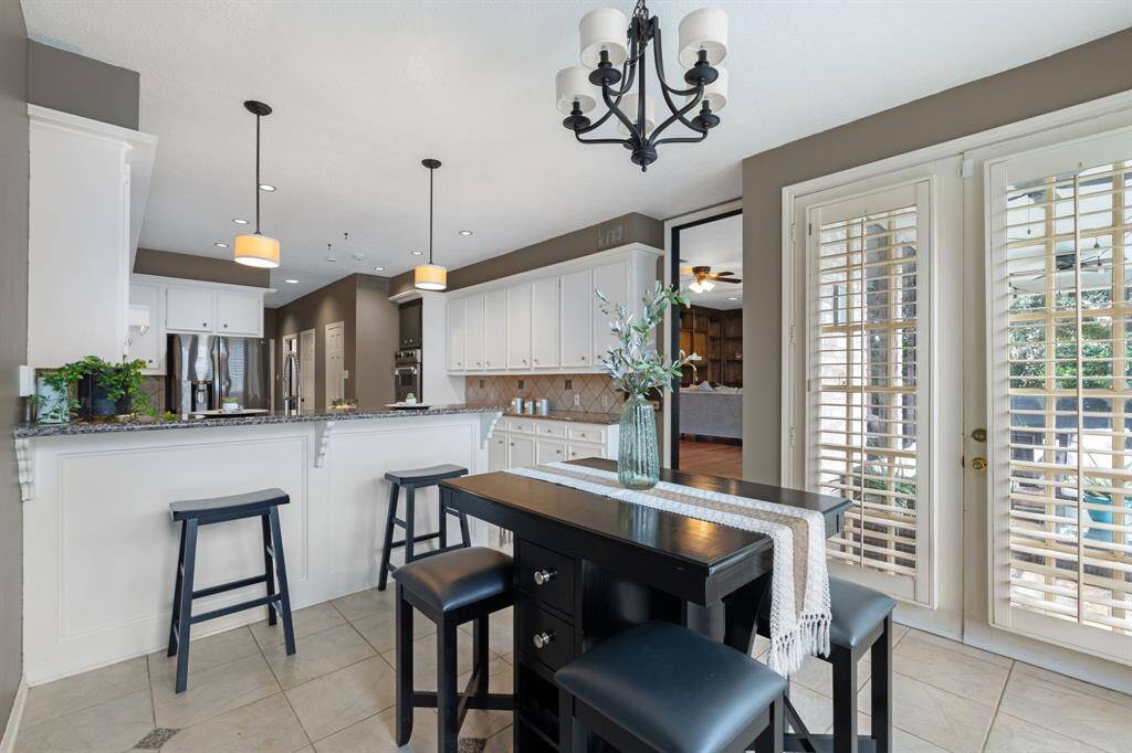 The entry to the breakfast area leads to an expansive seating area under the covered back patio.