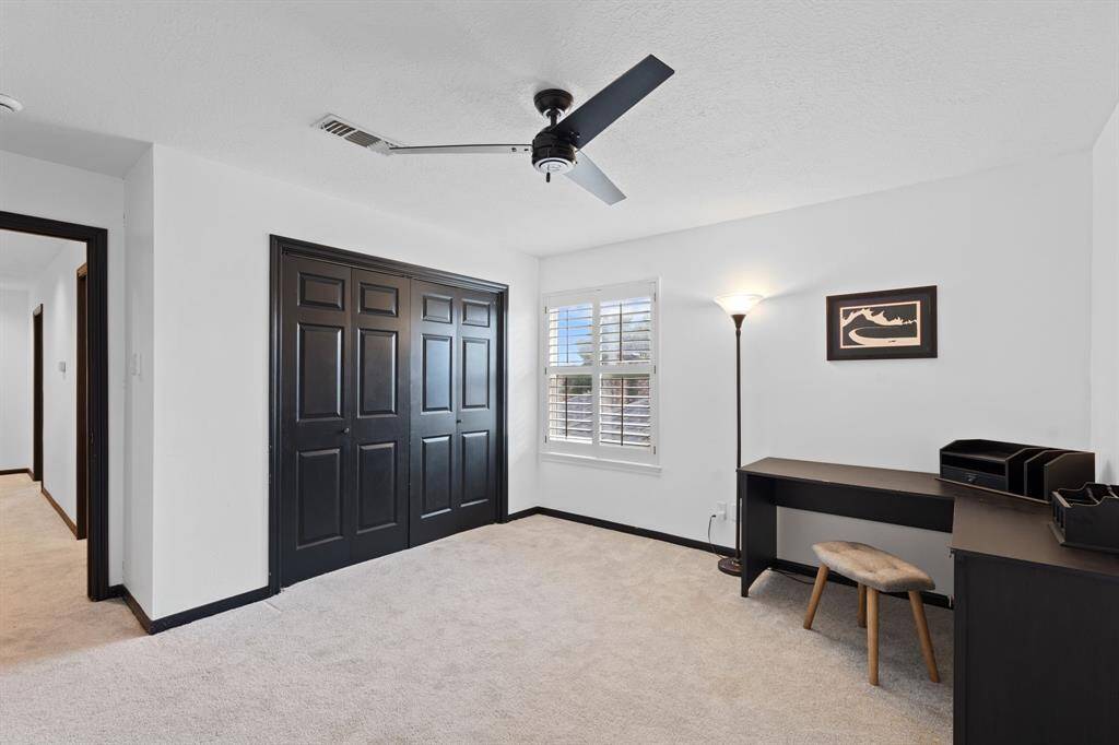Another view features the double-wide closet with built-in dresser and accordion style doors.