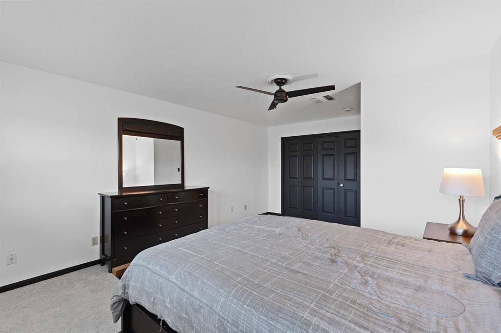 Another view shows the accordion style doors to the closet and custom fan.