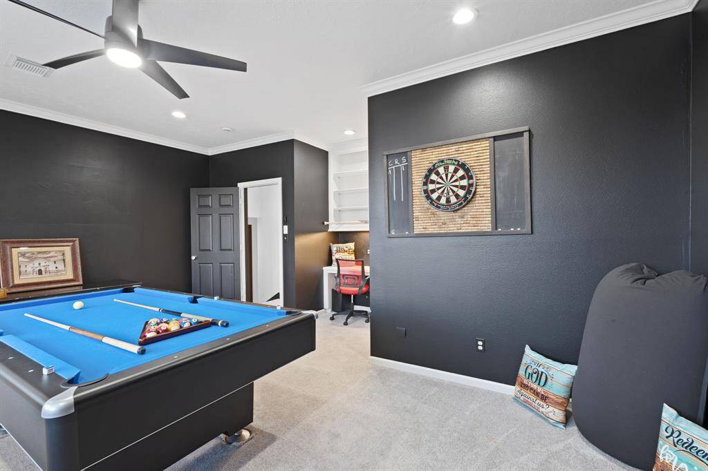 This room features a built-in desk and shelves with additional corner storage.