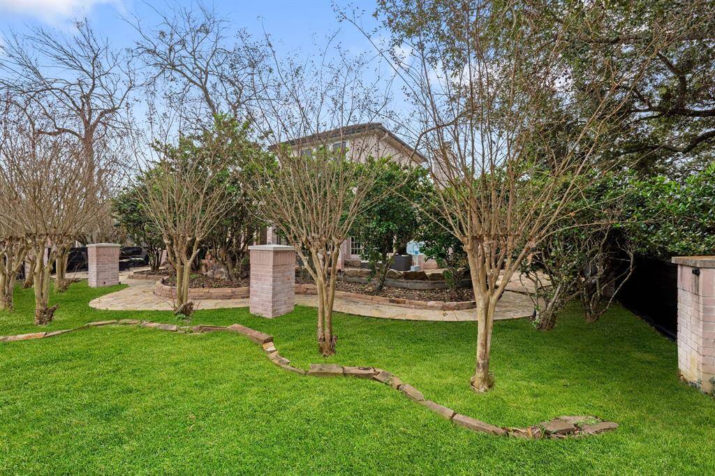 Beyond the pool and decking is a medium sized yard for pets to run around.