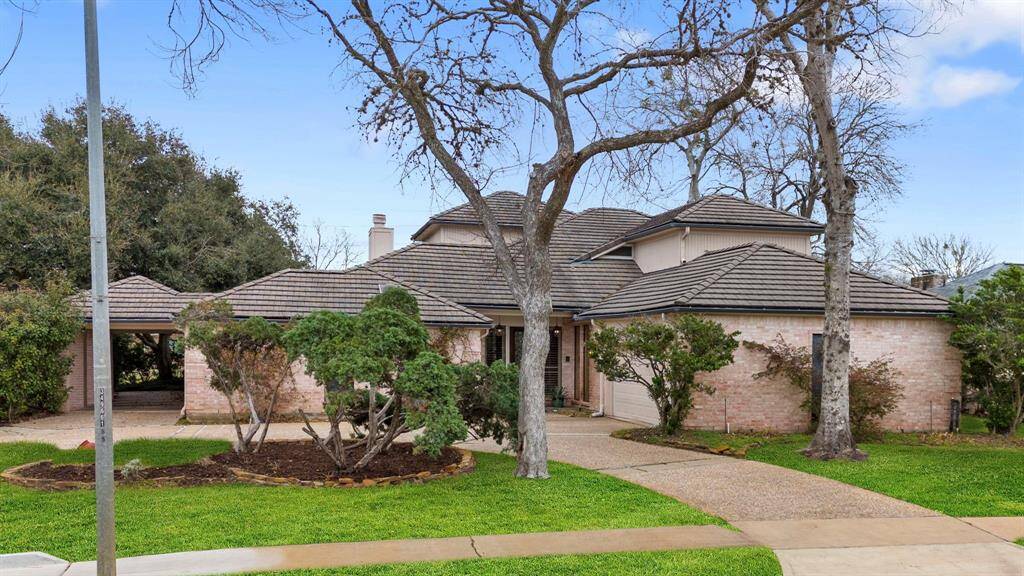 2 driveways, lush landscaping and concrete tile roof are just some of the desirable features here.