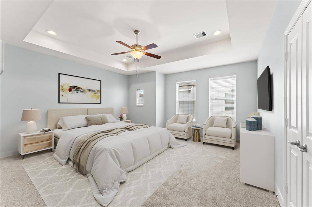 A true sanctuary, the master bedroom features a sophisticated tray ceiling, a gentle ceiling fan, and plush carpet flooring for ultimate comfort. Every detail is designed to bring a sense of relaxation, making it the perfect place to unwind at the end of the day.