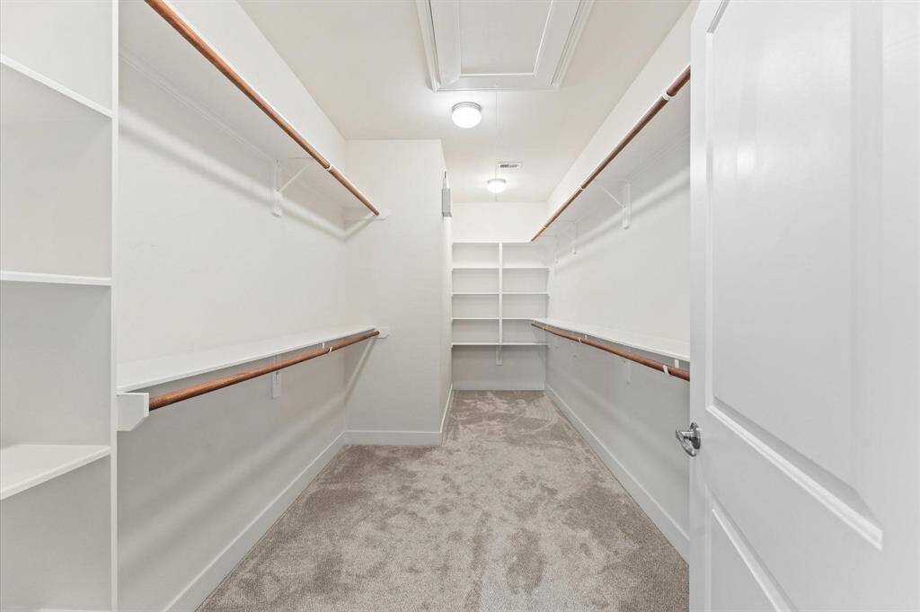 Step into a beautifully designed walk-in closet that blends style with function. Custom-built shelves and hanging rods provide ample space to keep everything neatly organized, from everyday essentials to cherished pieces.