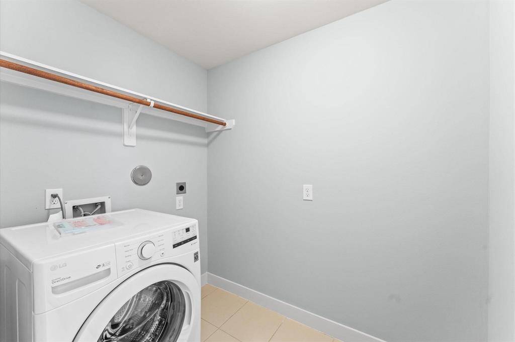 The laundry area adds convenience, making everyday chores effortless.
