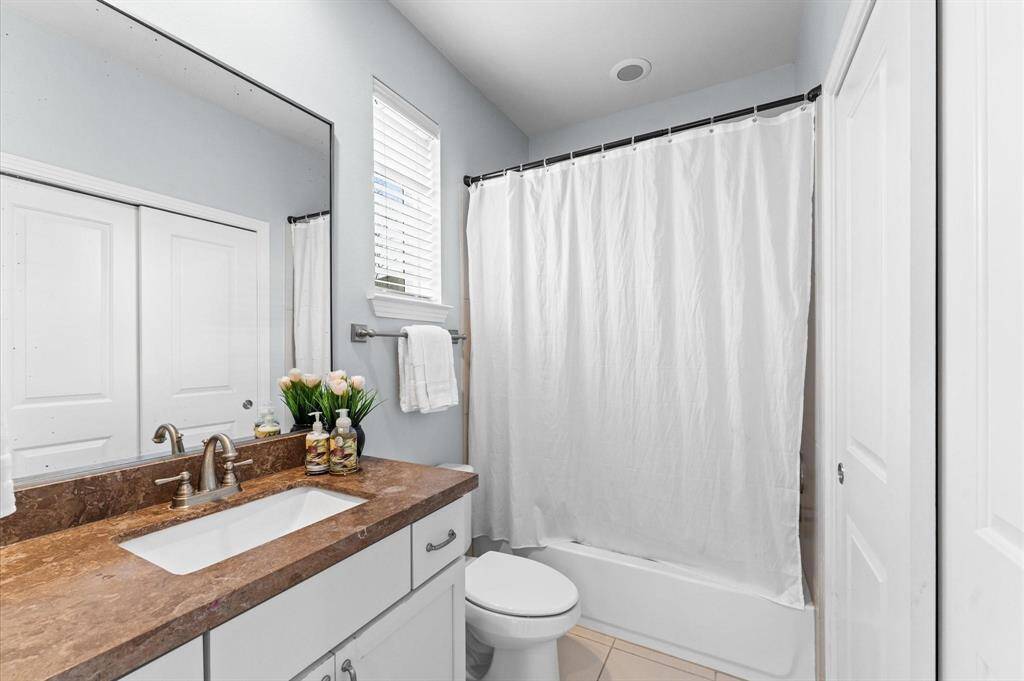 Sleek and functional, the first-floor en suite bathroom offers a private retreat.