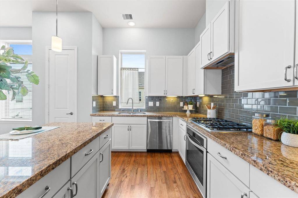 Custom white cabinets offer both elegance and function, providing plenty of space to keep everything organized.