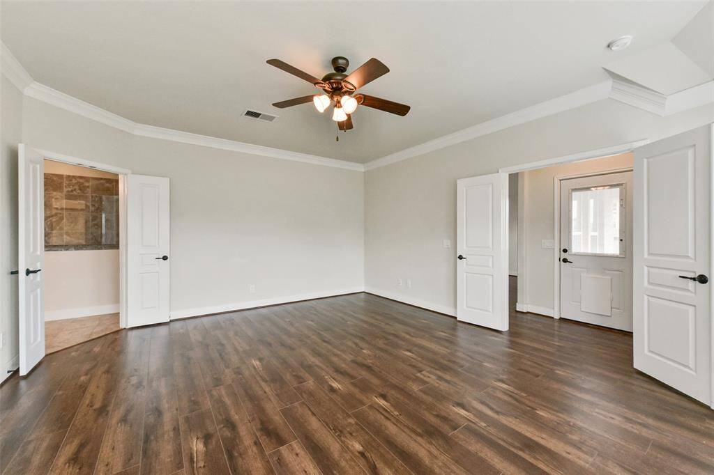 Primary Bedroom, elegant double doors at the room entry and leading to the ensuite bathroom
