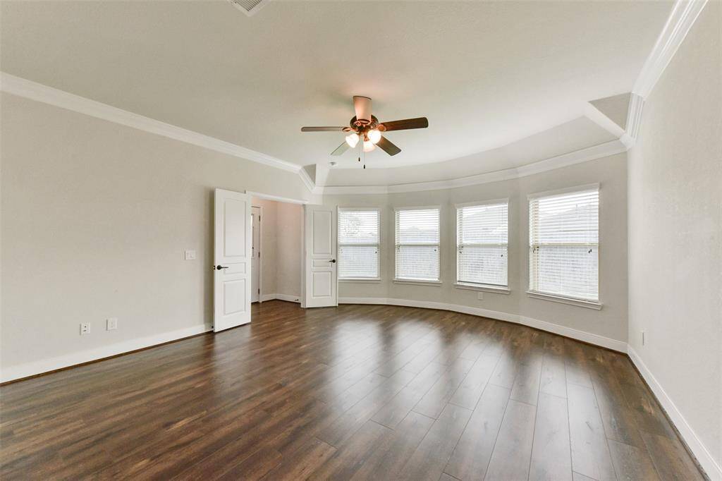 Bay windows in the primary bedroom fill the room with natural light.