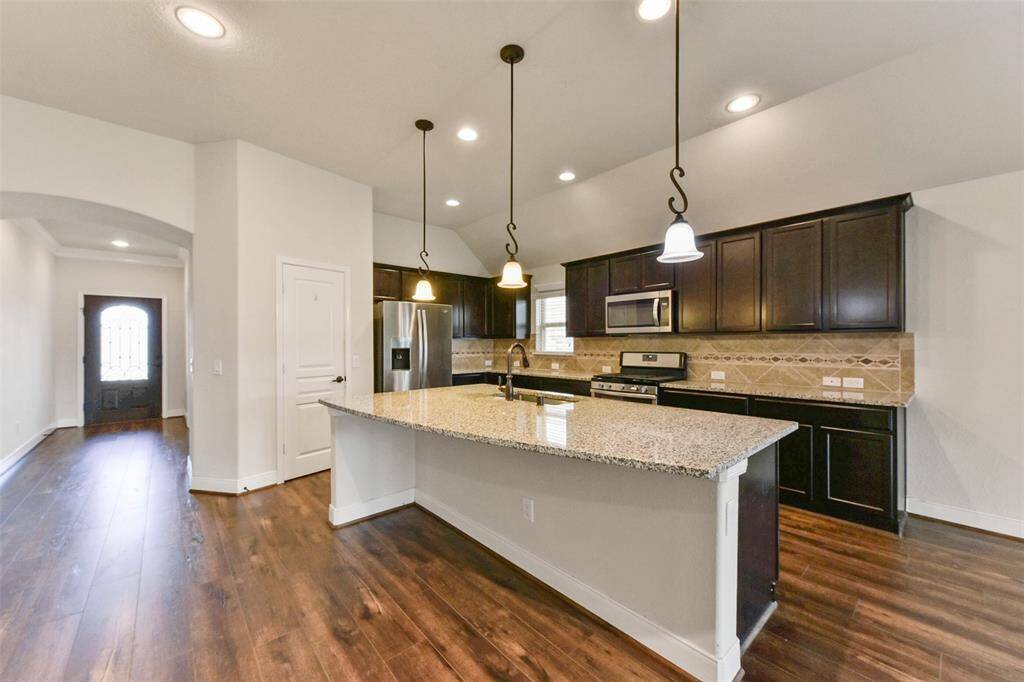 Large breakfast bar island with pendant lighting above.
