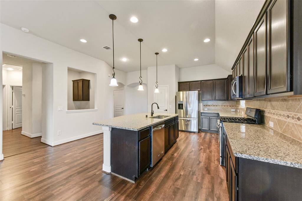 Rich dark cabinets and granite counters.