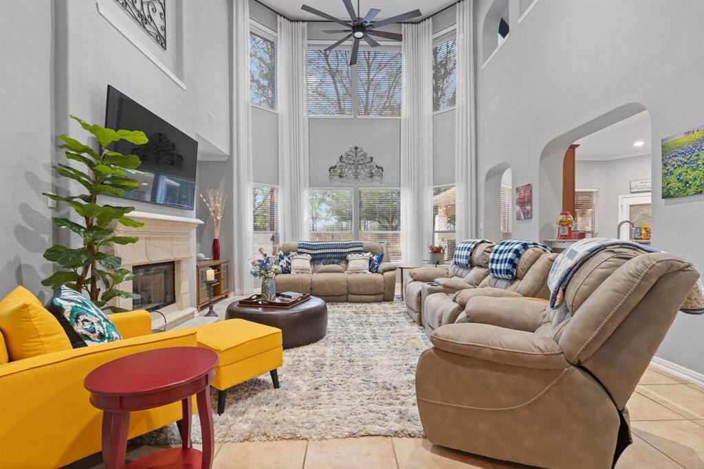 Bright, spacious living room with high ceilings and large windows that are perfect for family gatherings.