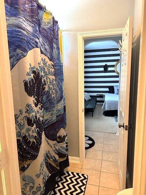 This photo shows a Jack and Jill bathroom with a tiled floor.
