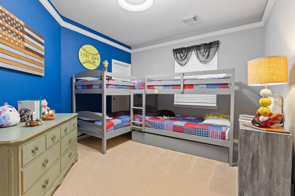 This large bedroom features vibrant blue and gray walls.
