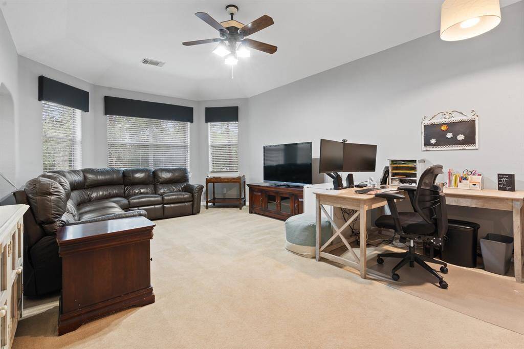 This is a spacious, well-lit living area/game room. It is ideal for work and relaxation.